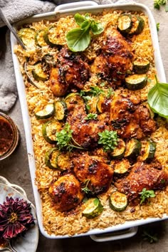 an overhead view of a casserole dish with chicken, zucchini and rice