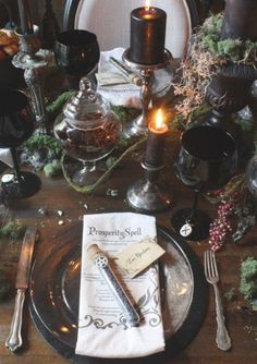 a table is set with silverware and candles