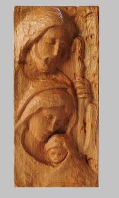 an image of the virgin mary and child jesus carved into wood, with text that reads