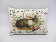 a pillow with a rabbit on it and the words carrot patch written in black ink