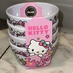 hello kitty cups are stacked on top of each other