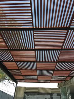 a wooden pergolated roof in front of a building