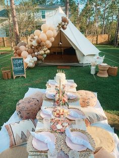 a table set up with balloons and plates