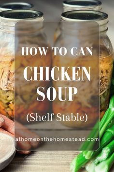 two jars filled with chicken soup sitting on top of a table next to green beans and carrots