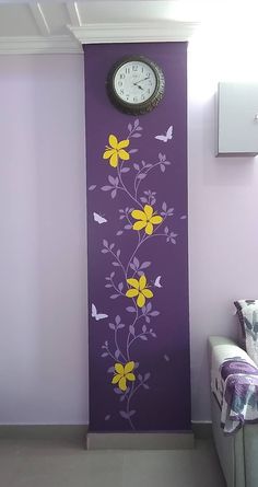 a clock mounted to the side of a purple wall