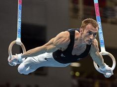 a man is doing tricks on the rings