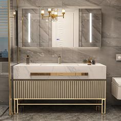 a bathroom with marble walls and flooring, gold fixtures on the sink countertop