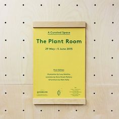 the plant room poster is hanging on the wall in front of polka dotty walls