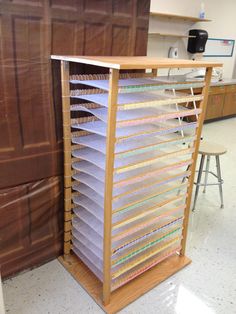 a large stack of papers sitting on top of a wooden shelf next to a counter