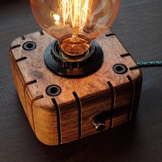 a light bulb is sitting on top of a wooden box that has been turned into a lamp