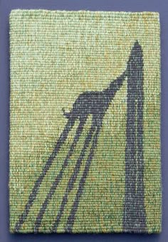 a needle - embroidered square with an image of a giraffe's shadow