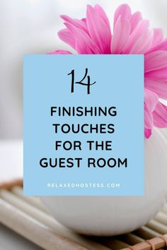 a pink flower in a white vase with the words finishing touches for the guest room