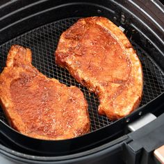 two steaks cooking in an open air fryer