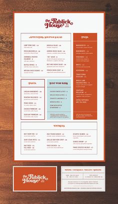 an orange and white menu on top of a wooden table