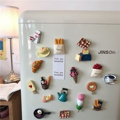 a refrigerator with magnets on it in a kitchen