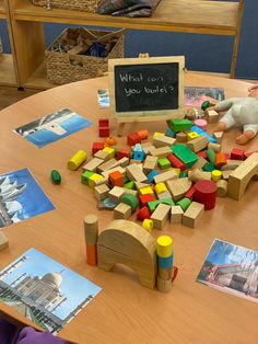 a child's table with toys and pictures on it, including a chalkboard that says what can you build?