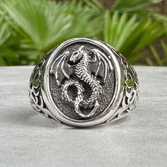 Handcrafted Solid Sterling Silver .925/ Amphiptere Ring 100% hand-polished solid sterling silver Approximate weight 9.7 grams Splendid Dragon ring with its feet holding on to a pentagram properly crafted in solid 925 sterling silver. Dragons is a well-known mythical creature from many ages and cultures. Dragon can symbolize supernatural power, wisdom, strength, and hidden knowledge. This unique dragon design is inspired by Celtics pattern. This magnificent piece will be a very good addition to y Oval Silver Engraved Ring, Symbolic Silver Engraved Round Ring, Symbolic Silver Rings With Polished Finish, Silver Symbolic Rings With Polished Finish, Silver Engraved Metal Ring, Nickel Free Sterling Silver Rings For Collectors, Silver Spiritual Skull Ring For Anniversary, Collectible Engraved Silver Sterling Ring, Symbolic Silver Hallmarked Rings