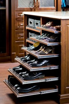 an organized shoe rack in the corner of a closet