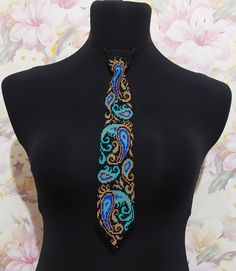 a black mannequin with a colorful beaded tie on it