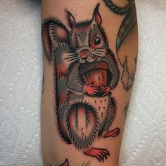 a close up of a person's leg with a tattoo on it and an image of a squirrel