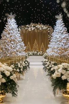 an aisle decorated with christmas trees and white flowers