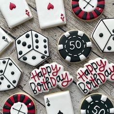 birthday cookies decorated with playing cards and dices on a wooden table next to chips