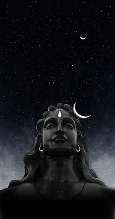 an image of the head of buddha with crescents and stars in the sky