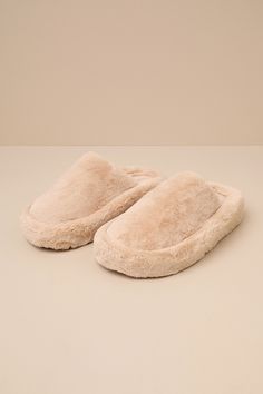 Slide through the day in maximum comfort (and style) thanks to the D'Amelio Footwear Socozee Beige Faux Fur Flatform Slippers! Super soft and fuzzy faux fur shapes the perfect slipper silhouette with a rounded toe upper and a slide-on design. Matching faux fur lines the interior for extra-cozy wear, while the chunky, flatform-inspired heel completes the look. Available in whole sizes only. 1. 75" wrapped heel. Cushioned insole. Felted rubber sole has nonskid markings. Man Made Materials. Importe Comfortable Flat Faux Fur Slippers, Comfortable Faux Fur Flat Slippers, Cozy Fluffy Flat Slippers, Fluffy Flat Faux Fur Slippers, Fluffy Faux Fur Flat Slippers, Winter Slippers With Faux Fur Lining For Loungewear, Fluffy Slippers For Winter Loungewear, Winter Faux Fur Lined Slippers For Loungewear, Winter Loungewear Slippers With Faux Fur Lining