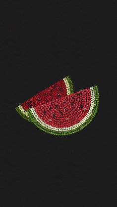 a slice of watermelon on a black shirt with green and red trims