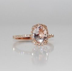 an image of a ring with diamonds on the side and a pink diamond in the middle