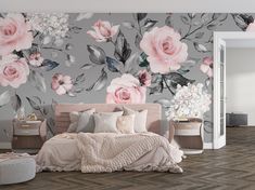 a bedroom with floral wallpaper and pink bedding