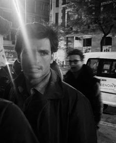 black and white photograph of three men walking down the street