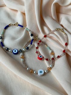 Beaded evil eye anklet available in red, beige or blue. Wear on its own or layer up Beads Bracelets Evil Eye, Cheap Evil Eye Bracelets For Beach, Beaded Accessories Novica, Cheap Adjustable Evil Eye Bracelet With Sliding Knot, Cheap Multicolor Evil Eye Bracelet With Round Beads, Beaded Jewelry Anklet, Cheap Adjustable Turquoise Evil Eye Bracelet, Cheap Evil Eye Festival Jewelry, Evil Eye Diy Bracelet