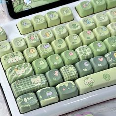 the keyboard is decorated with green and white designs