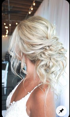 the back of a woman's head with blonde hair in a low bun braid