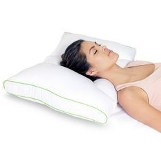 a woman laying down on a pillow with her eyes closed