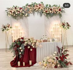 a white table topped with flowers and candles