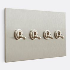 three switches are mounted to the wall with metal handles and numbers on each switch plate