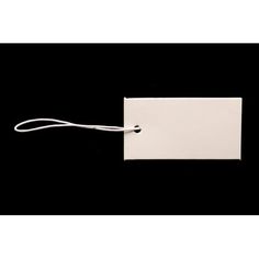 an empty white tag with a string attached to it on a black background in the dark