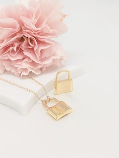 "All items ordered 5/14/21 - 5/30/21 will be shipped out on 5/31/21 Our gift to you 10% off your first purchase. Details here - http:/eepurl.com/dpVPBz Our love lock necklaces are perfect stand alone or layering pieces. Locks are suspended on our signature gold fill chain. Lots of love and symbolism in these pieces. They make thoughtful gifts or that something special for yourself! DETAILS 14 k fill chain and components Charm high shine finish gold plate This listing is for one tiny lock necklac Small Everyday Necklace With Charms, Everyday Locket Pendant Charm Necklace, Everyday Initial Pendant Locket Charm Necklace, Small Charm Necklace With Lobster Clasp For Gift, Minimalist Lock Jewelry As A Gift, Minimalist Jewelry With Lock As A Gift, Minimalist Lock Jewelry As Gift, Minimalist Everyday Jewelry With Lock Detail, Minimalist Lock Jewelry For Gifts