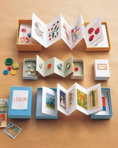 an open book sitting on top of a wooden table next to other books and magnets