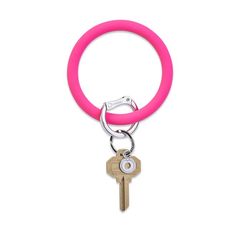 a pink ring with a key hanging from it