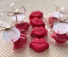 some candy shaped like lips are on a plate with tags attached to the top of them