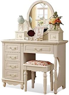 a white dressing table with a mirror and stool