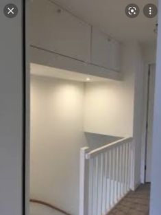 an empty room with white walls and wood flooring is seen through the door frame