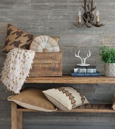 a wooden table topped with lots of pillows