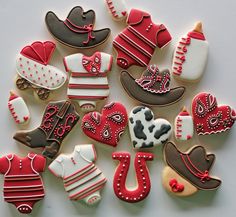 decorated cookies are arranged in the shape of cowboy hats, boots, and booties