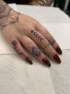 a woman's hand with some tattoos on it