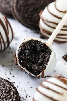 chocolate covered oreo pops with white and dark chocolate drizzled on top