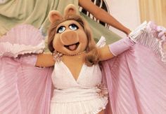 the miss piggy doll is dressed in pink